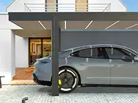 Ein graues Auto parkt unter einem modernen Carport vor einem stilvollen Haus.